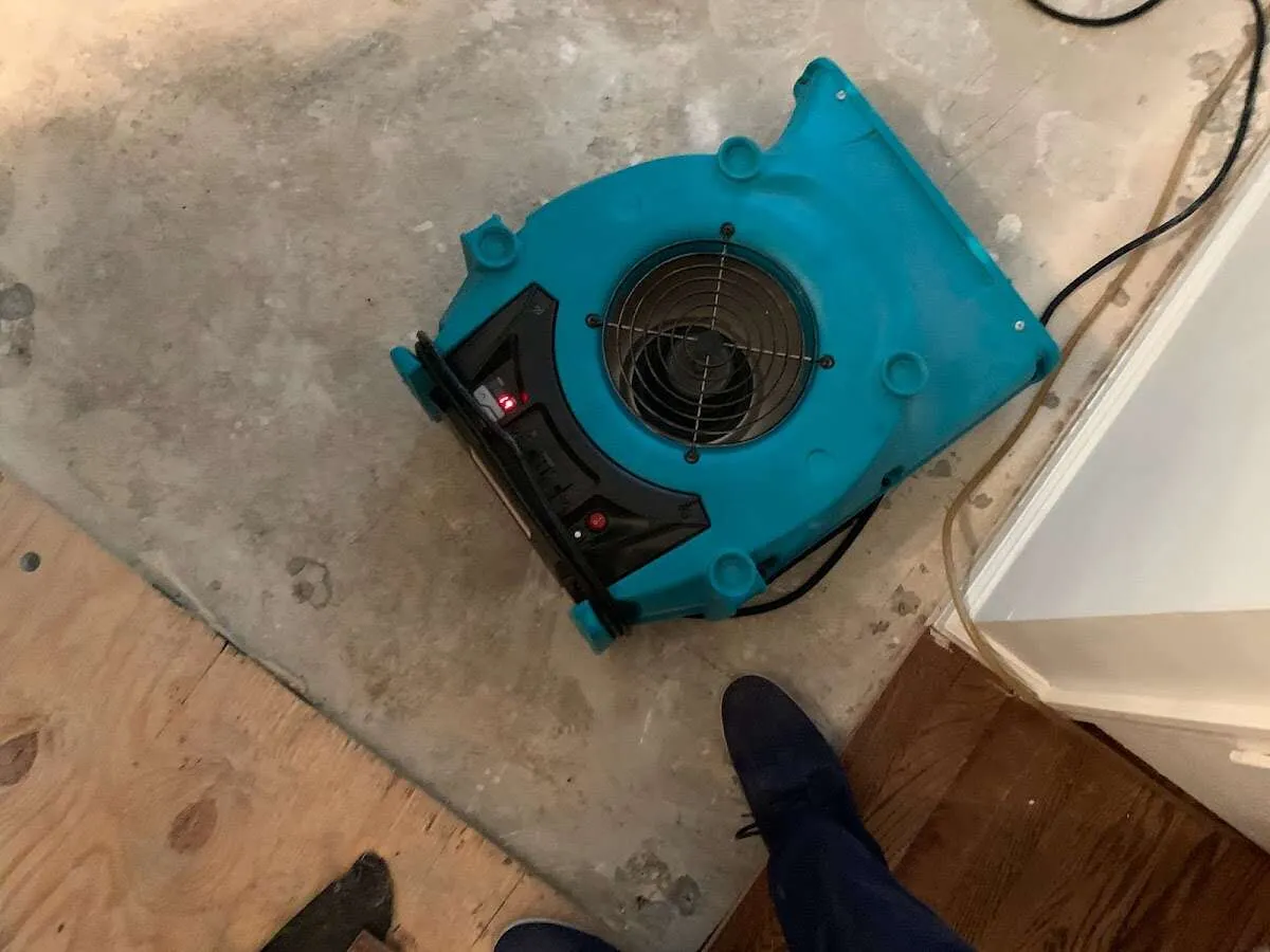 Air mover drying subfloor during Leak Detection & Repair in West Pennsboro